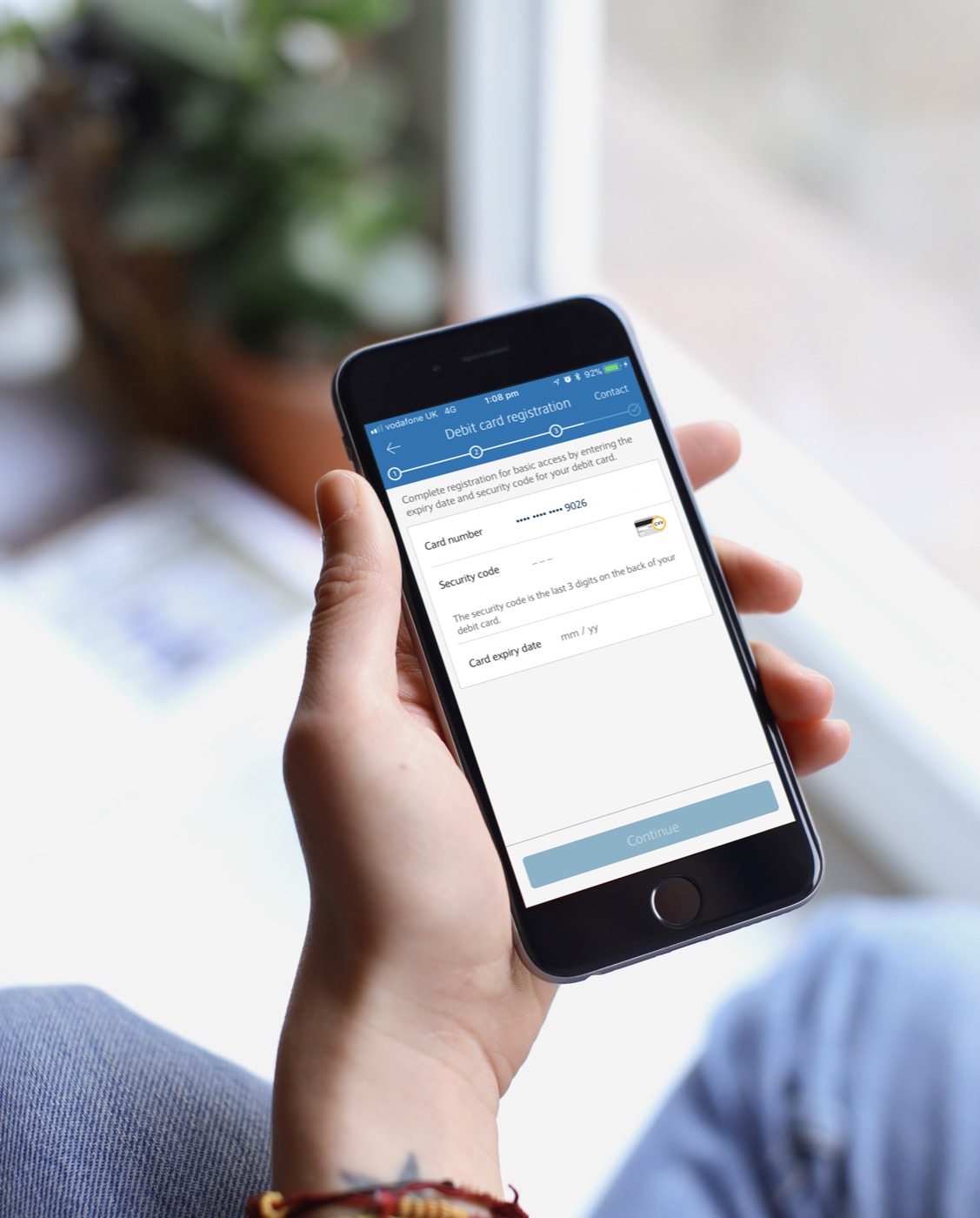 A phone showing the debit card registration screen