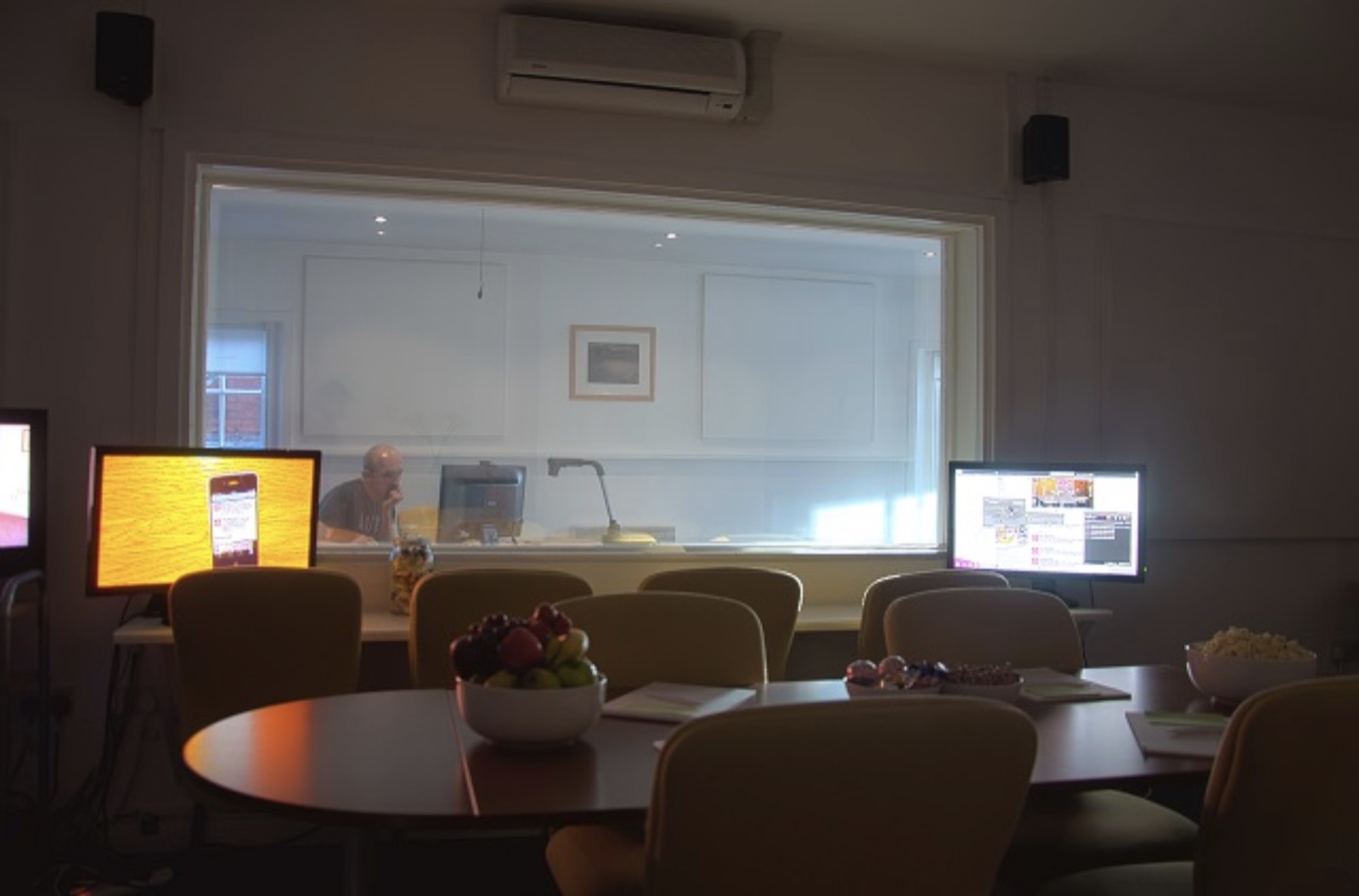 Observation room with a two-way mirror and screens