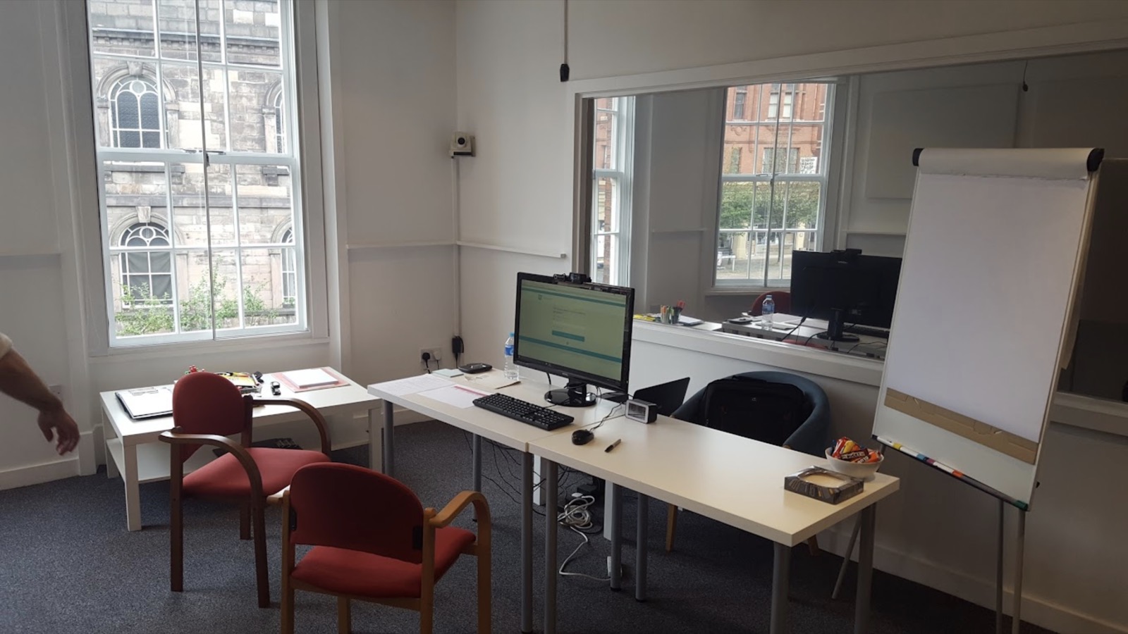 Customer testing room with a desk, computer and flip chart