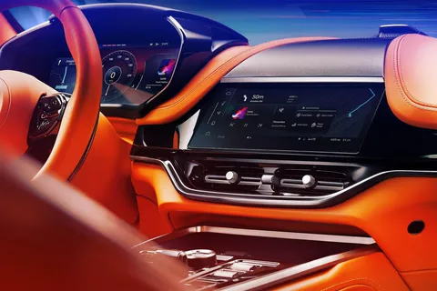 DBX707 cabin with the steering wheel, the instrument cluster and the central infotainment touchscreen above the centre console.