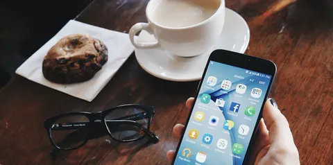 A phone and a coffee on a table