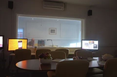 Observation room with a two-way mirror and screens